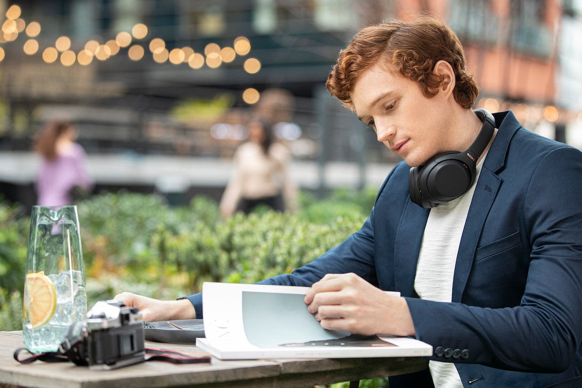 WH-1000XM4 headphones around the neck in a cafe