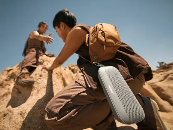 Two friends rock climbing listening to a Bose SoundLink Flex Portable Speaker (2nd Gen)